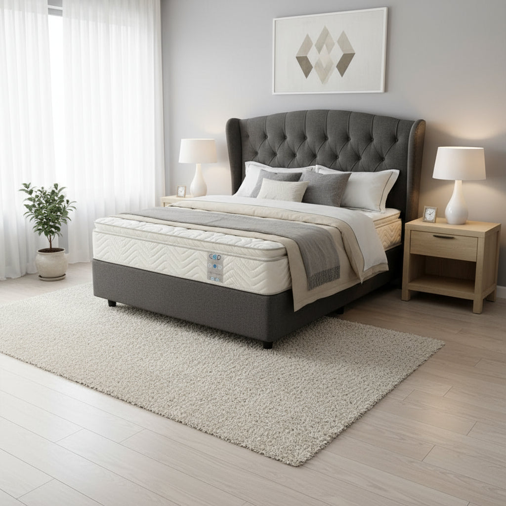 Mattress on a bed frame in a room with a plant and window.