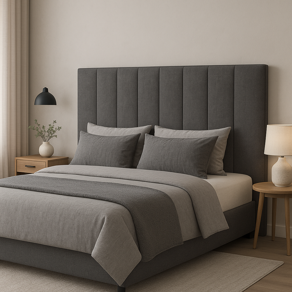 Gray upholstered bed with matching headboard and bedding in a bedroom setting.