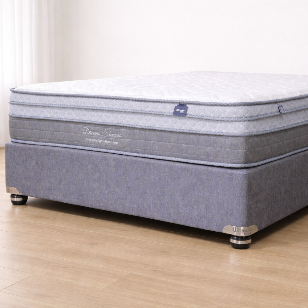 Gray mattress on a wooden floor with a white wall background