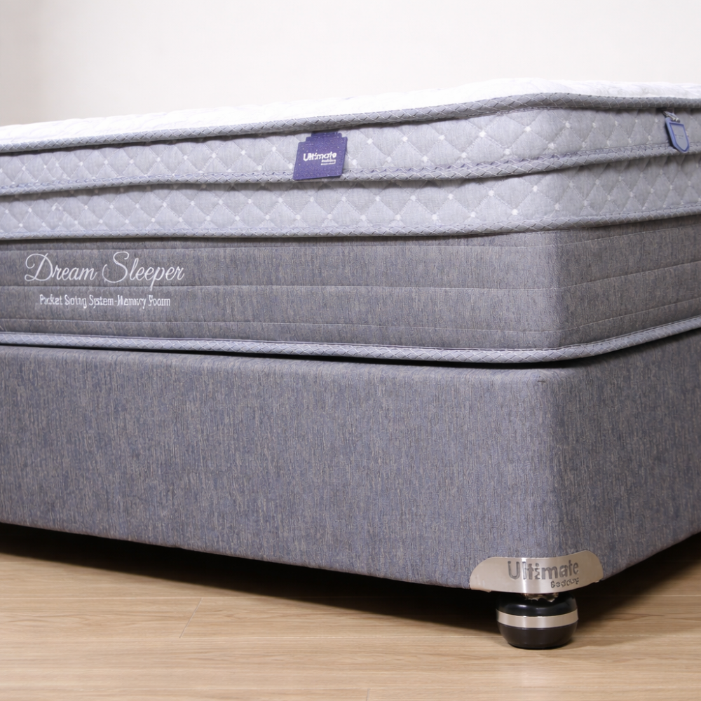 Gray mattress with 'Dream Sleeper' branding on a wooden floor.