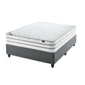 A firm white mattress on a single extra length bed with a grey bed frame.
