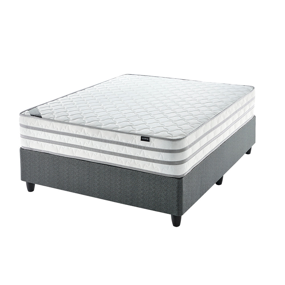 A firm white mattress on a single extra length bed with a grey bed frame.
