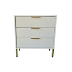 White dresser with gold handles on a white background