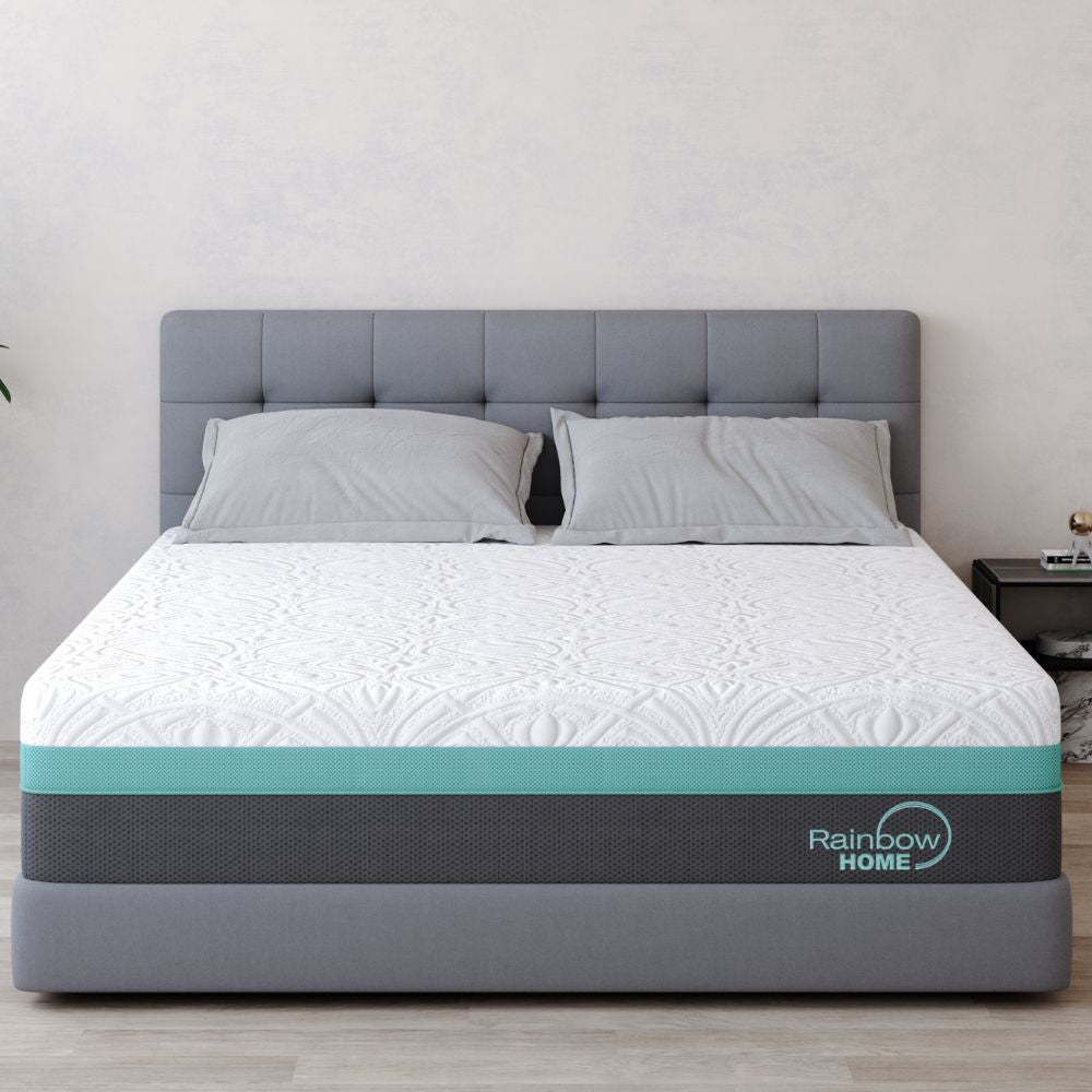 A double mattress with a plush top, pocket spring core, and a gray bottom, branded 'Rainbow Home', displayed on a bed frame with a gray headboard.