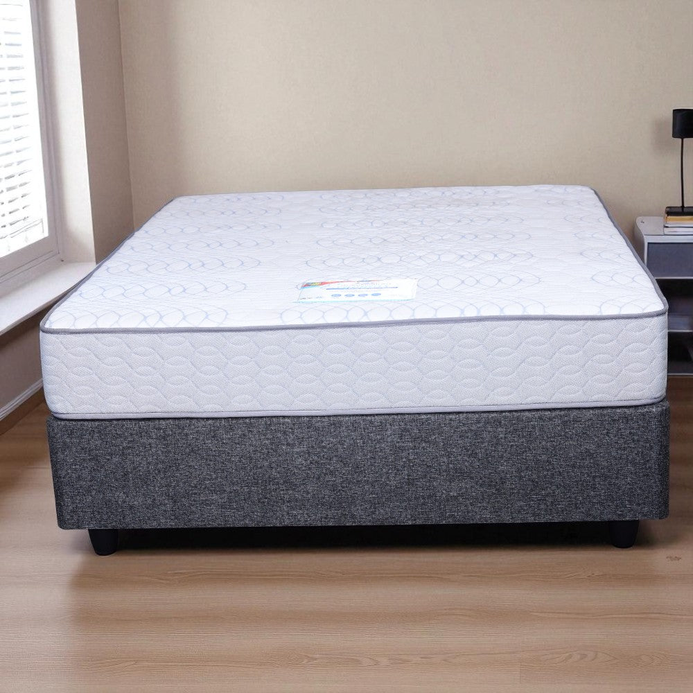 Mattress on a wooden floor with a neutral wall background