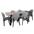 Wooden dining table with six gray chairs on a white background