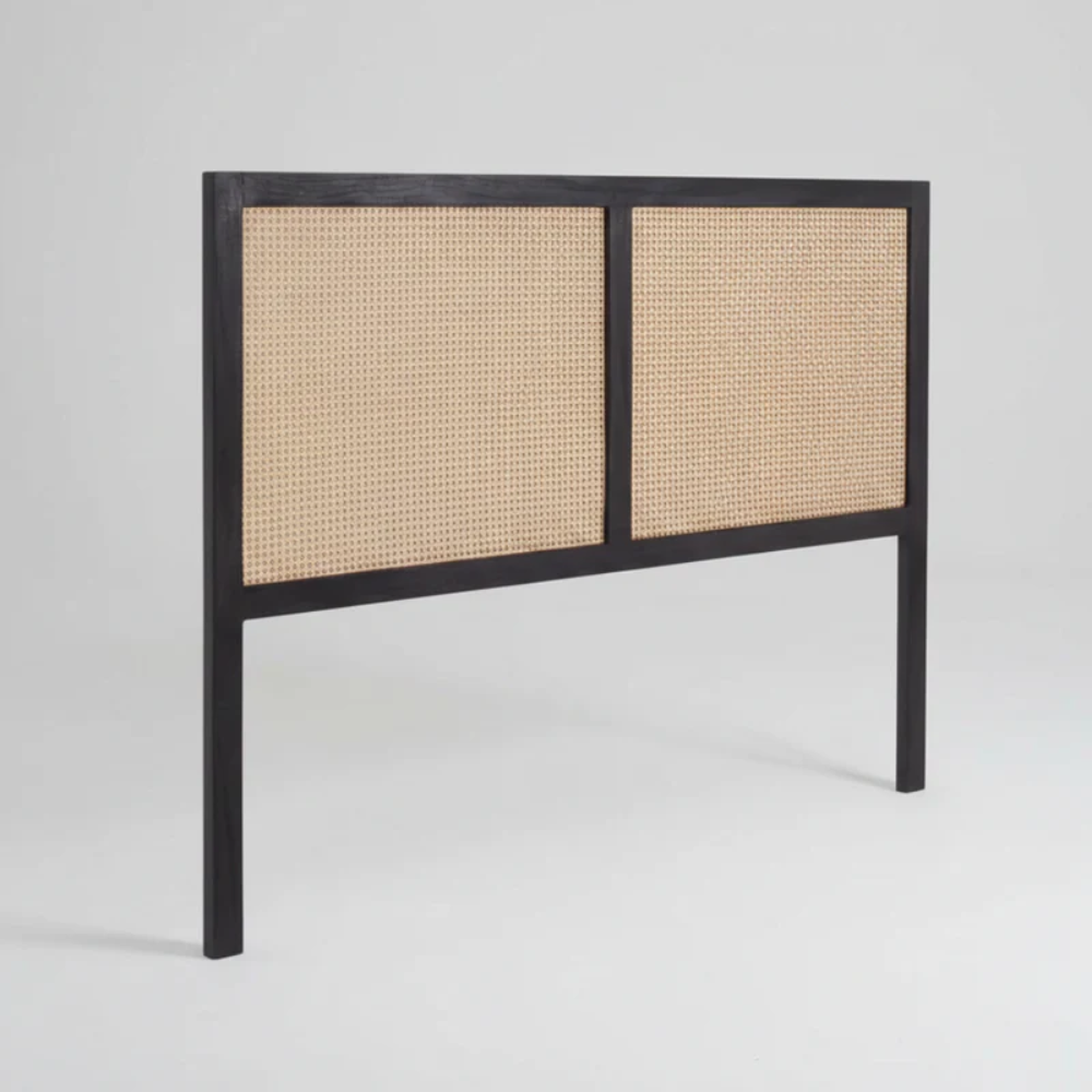 Headboard with black frame and woven natural material on a gray background