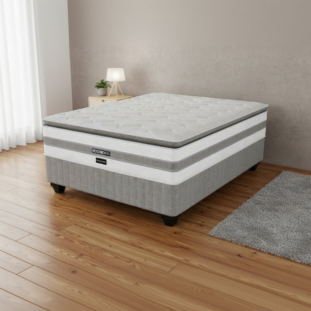 Gray and white mattress with 'RESTONEL' branding on a white background